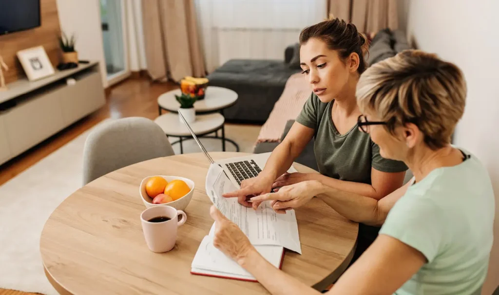 Mother + Daughter reviewing documents at breakfast